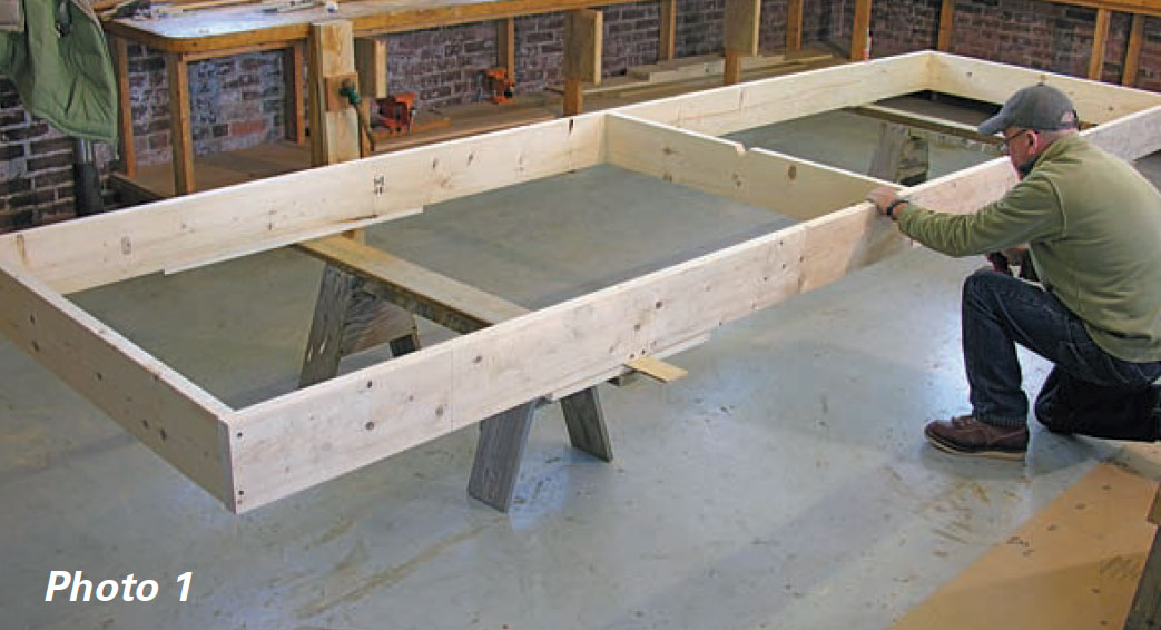 Boatbuilder makes a strongback ladder frame with two 15-foot straight 2x8" spruce planks and three 36" 2x8" "rungs."