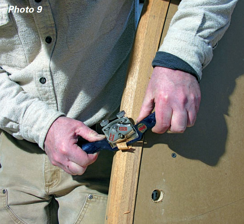 Man uses spokeshave to bevel a piece of wood.