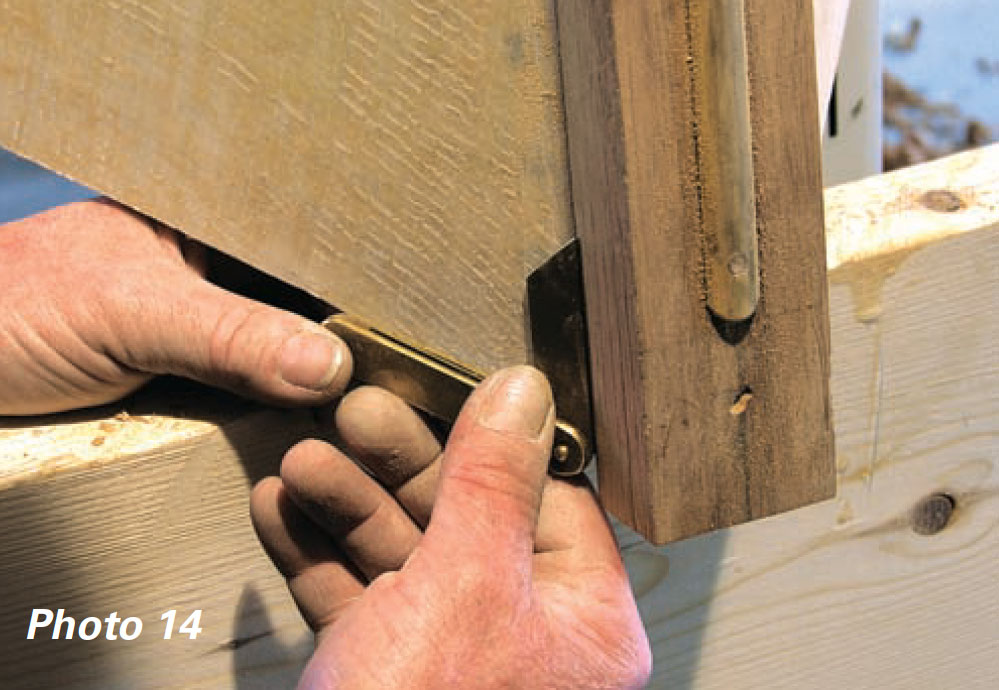 Hands holding a bevel gauge to a piece of wood.