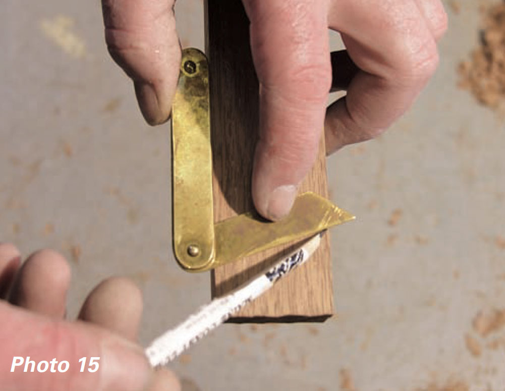 Hands use a bevel gauge and pencil to make a mark on wood.