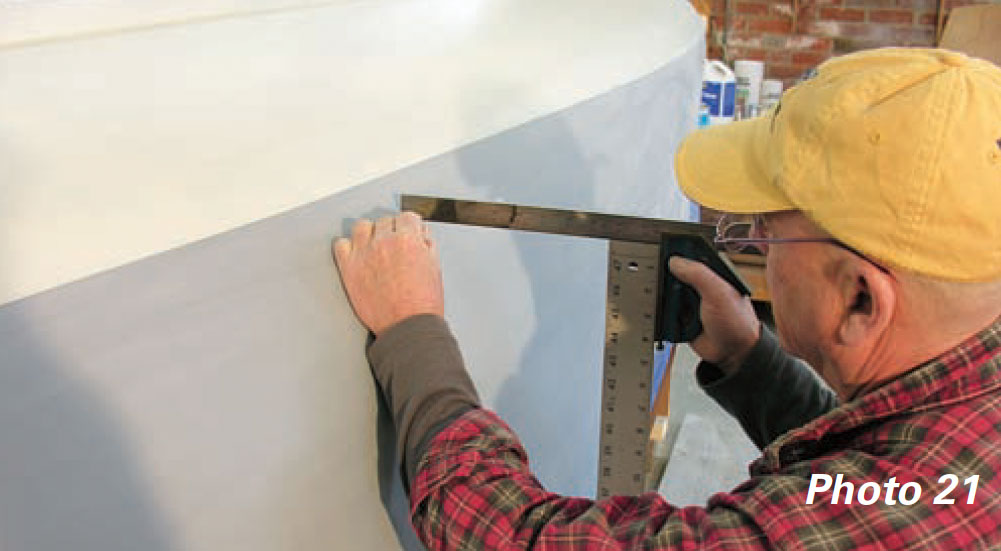 Man uses simple jig to measure a boat's designed waterline.