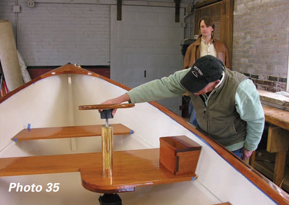 Boatbuilders give a boat's steering wheel a final check.