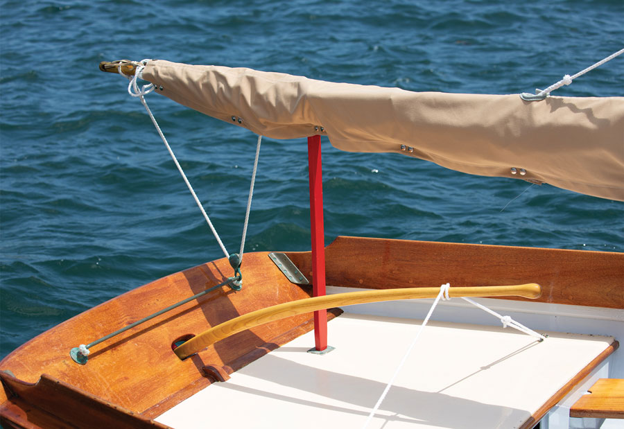 Sailboat stern with mainsheet fastened with brass traveler.