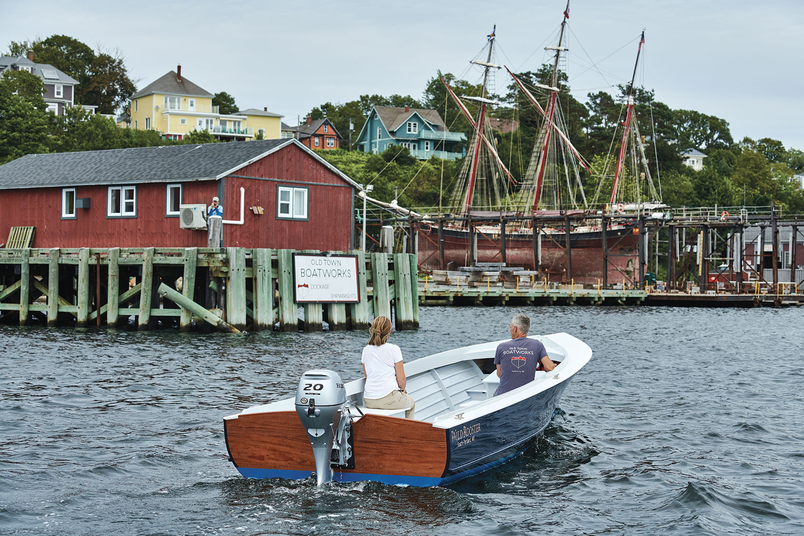 Rear view of the WILD ROOSTER powerboat with two riders.